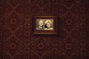 pictures of a man and woman hanging on a red wall