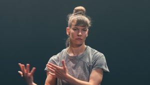woman in grey t-shirt in a dance performance