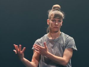 woman in grey t-shirt in a dance performance