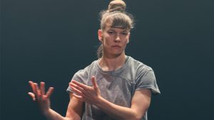 woman in grey t-shirt in a dance performance