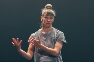 woman in grey t-shirt in a dance performance