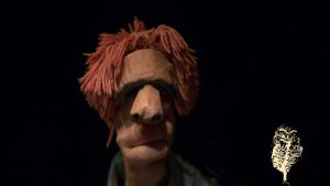 slose up of hand puppet with red hair
