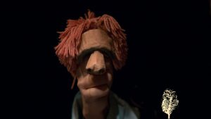 slose up of hand puppet with red hair